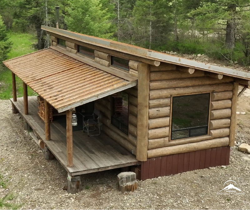 Full log construction with a wide covered porch and clerestory windows.