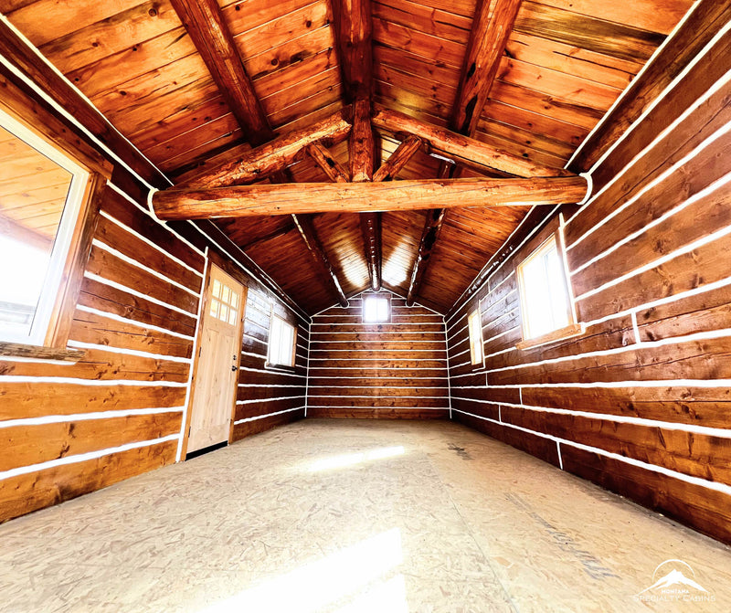 Open interior with exposed log trusses and high ceiling